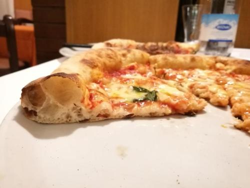 a slice of pizza sitting on top of a table at Motel Villaggio in Imola