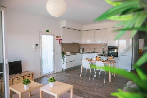 a kitchen and dining room with a table and chairs at Marlin House III in Peniche