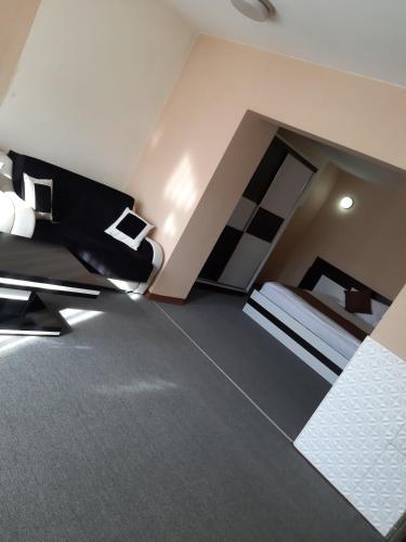 a large room with two beds and a couch at Meka Hotel in Dragash