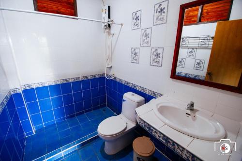 a bathroom with a toilet and a sink at Venus Resort in Haad Rin
