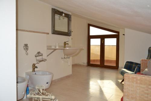 a bathroom with a sink and a bath tub in a room at Villaiale in Sassari