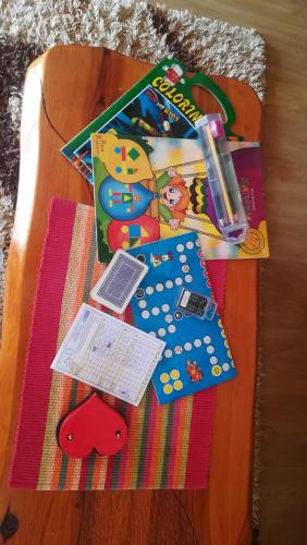 a wooden table with a book and other items on it at Vikendica NEVEN in Zaovine