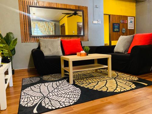 a living room with a couch and a coffee table at Ammar Homestay in Kuala Terengganu