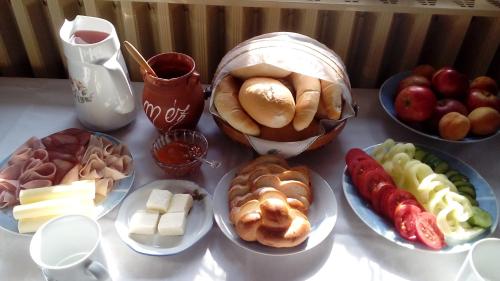 a table with plates of different types of food at Mézeskuckó in Tiszaszőlős