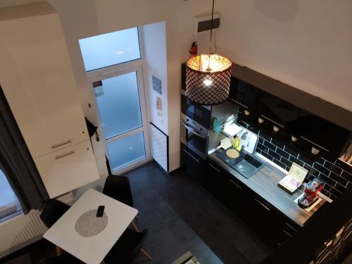 an overhead view of a small kitchen with a table at DownTown DeLuxe Apartment in Eger