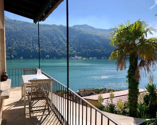 a balcony of a house with a view of the water at Casa al Sole in Morcote