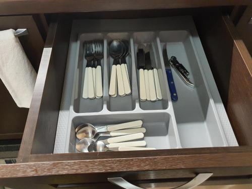 a drawer with utensils and utensils at Koko's apartments in Bansko