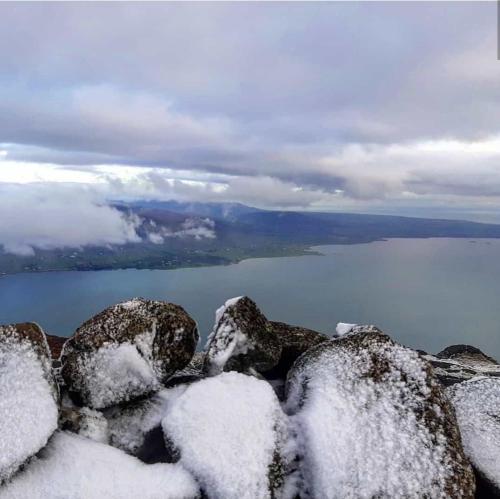 a view of snow covered rocks and a body of water at Greencastle B&B in Kilkeel