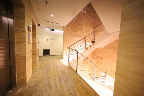 a hallway with a staircase in a building at Eva Hotel in Jeddah