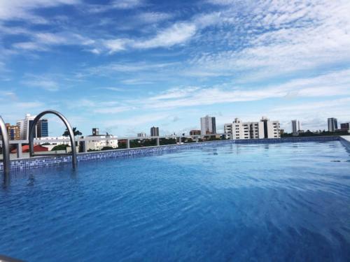 una gran piscina con una ciudad en el fondo en Pacifico Apart Hotel, en Santa Cruz de la Sierra