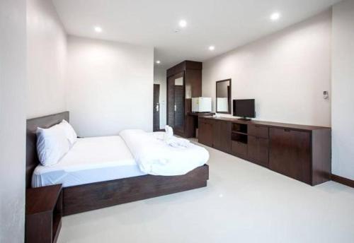 a bedroom with a bed and a television in it at Amatara Hotel in Pi Mai