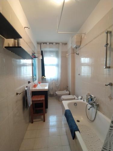 a bathroom with a tub and a toilet and a sink at The Architect in Bari Palese