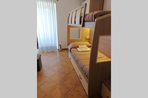 a small room with a bunk bed with a desk at Casa Stefania in Barrea