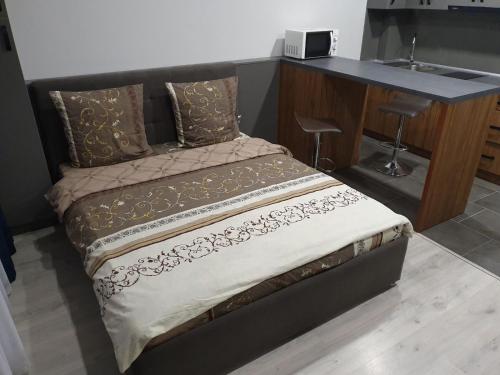 un letto in una camera accanto a una scrivania di Silver Star Apartment a Užhorod