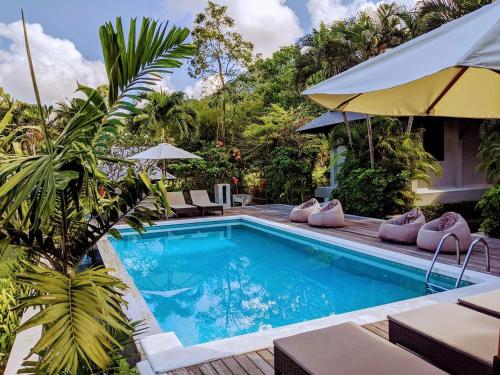 a swimming pool with lounge chairs and a resort at villa inspiration in Ko Chang