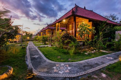 a house with a pathway in front of it at D'Coin Lembongan in Nusa Lembongan
