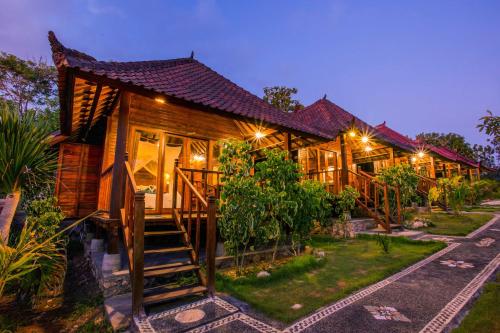 a house with a staircase leading to it at night at D'Coin Lembongan in Nusa Lembongan