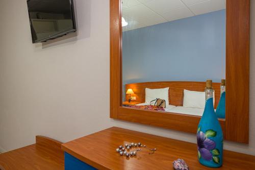 a hotel room with a bed and a mirror at Maria Studios in Keri