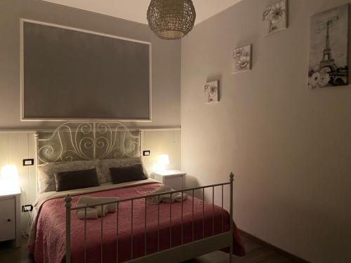 a bedroom with a bed with a red bedspread at Sweet Rome B&B in Rome