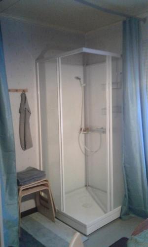 a white shower in a room with a curtain at Holiday House in Lapland, Överkalix in Överkalix