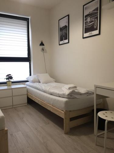 Ένα ή περισσότερα κρεβάτια σε δωμάτιο στο Apartament Kraków Arena No 76