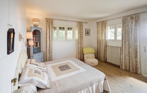 a bedroom with a bed and a chair at Beautifull Villa French Rivera in Spéracèdes