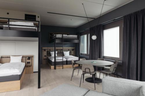 a bedroom with bunk beds and a table and chairs at Comfort Hotel Arlanda Airport Terminal in Arlanda