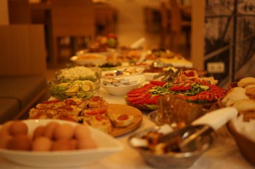 a table topped with lots of different types of food at Hotel Emen in Mostar