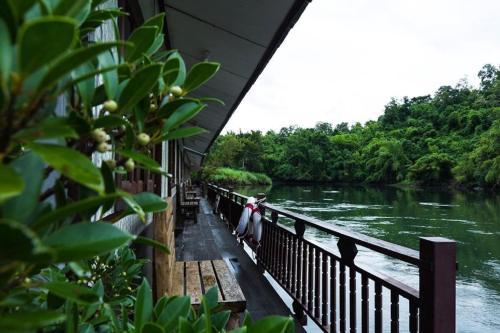 a person sitting on a balcony looking at a river at Nakakiri Resort & Spa in Hin Dat