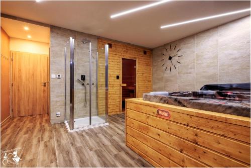a large bathroom with a shower and a tub at Chata Harmónia Hrabovo in Ružomberok