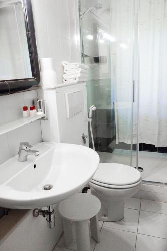 a bathroom with a sink and a toilet and a shower at Hotel Letizia in Orte