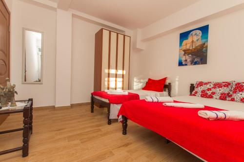 a room with two beds with red sheets at Apartments Petković in Petrovac na Moru