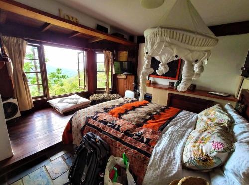 a bedroom with a large bed with a canopy at The Den of the Treehouse, KINABALU Farm in The Pocket
