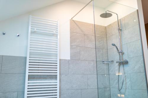 a bathroom with a shower with a glass door at Gasthof Krone Ochsenfeld in Ochsenfeld