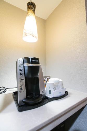 a coffeemaker sitting on a counter in a hotel room at Wingate by Wyndham - DFW North in Irving