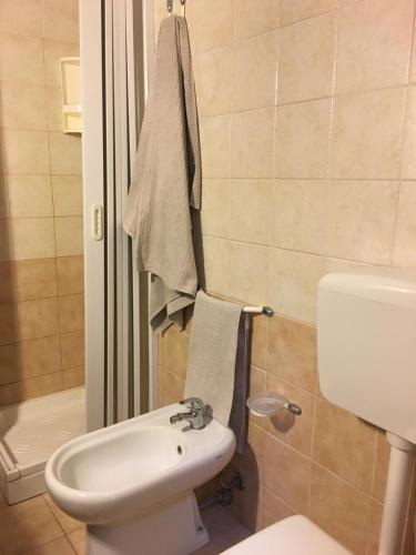 a bathroom with a white toilet and a sink at Appartamento Il Corallo Blu in Lampedusa