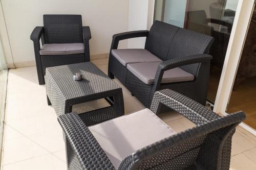 a room with two chairs and a couch and a table at Apartments Menuet in Budva