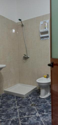 a bathroom with a shower with a toilet and a sink at Lovely Apartment 2 in Golem