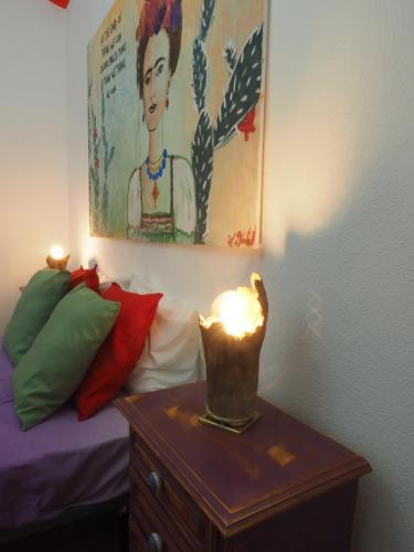 a candle on a table next to a bed at The Portuguese Element in Faro