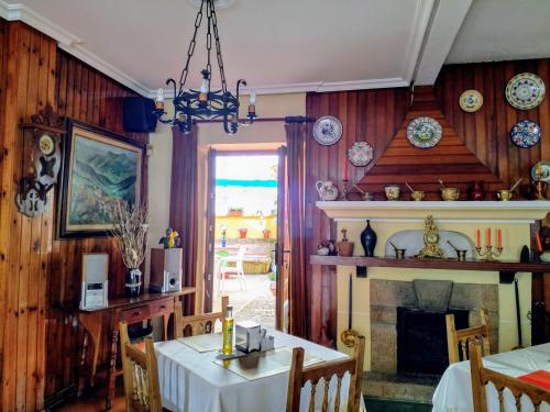 a dining room with a table and a fireplace at Hosteria Picos De Europa in Potes