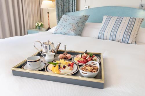 
a tray filled with food on top of a bed at Hotel Costa Galana in Mar del Plata
