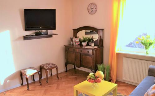 a living room with a tv on the wall at Romantic Old City Gdansk in Gdańsk