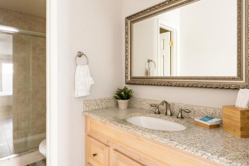a bathroom with a sink and a mirror at Central Phoenix Townhome in Phoenix