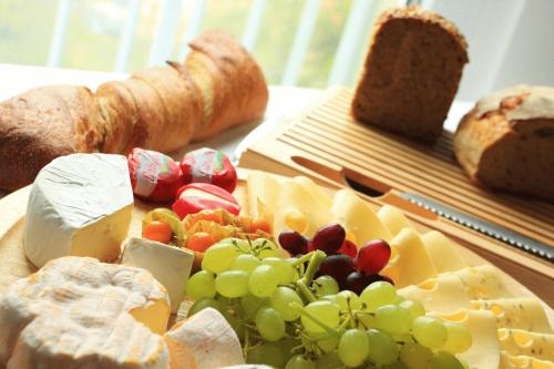 a bunch of cheese and grapes and bread on a table at Klozbücher - Das Landhotel in Ellwangen