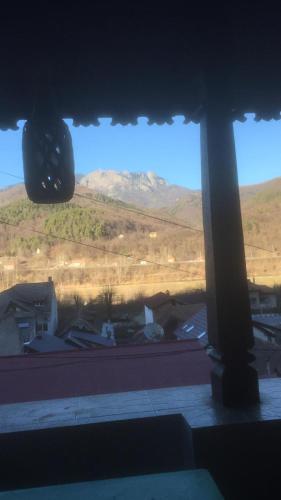 a view of a mountain from a window at Vila Licurici in Caciulata