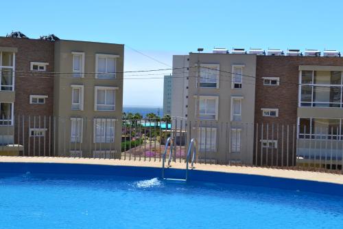 Πισίνα στο ή κοντά στο Lomas de Papudo 1 - Departamento a pasos de la playa