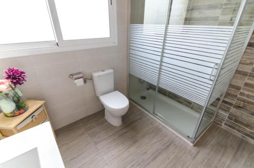 a bathroom with a toilet and a glass shower at Club Villamar - Aygo in Maçanet de la Selva