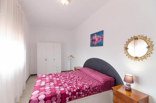 a bedroom with a pink bed and a mirror at Club Villamar - Aygo in Maçanet de la Selva