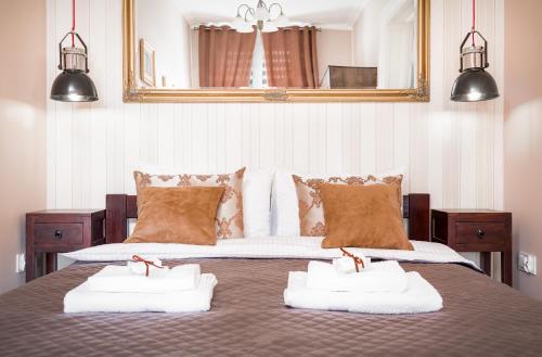a bedroom with a bed with two towels on it at Comfort Studio Central in Szczecin