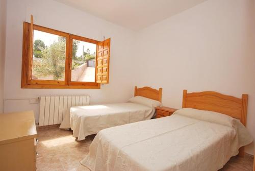 Un pat sau paturi într-o cameră la Club Villamar - Tinoco